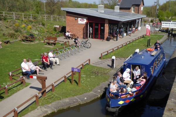 group of people on a canal boat at hollingwood hub enjoying a boat ride on a working canal aided by Chesterfield Canal Trust