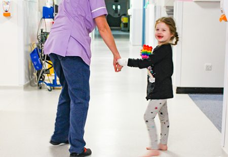 1 female healthcare professional and a young girl on a childrens hospital ward
