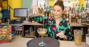 Monica from Sicily Restaurant pouring a coffee cocktail from a height into a glass