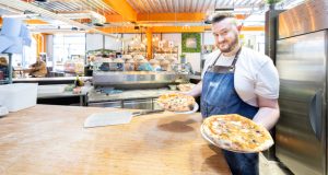Chef holding 2 pizzas in kitchen at The Batchhouse Chesterfield