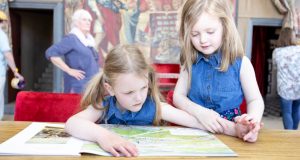 Two young girls reading on a table at Bolsover Castle