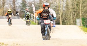 Young rider on bmx, other riders in background