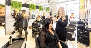female stylist curling hair for customer at MD Hair, Chesterfield