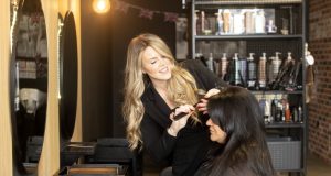female stylist curling hair for customer at MD Hair, Chesterfield