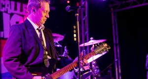 Guitarist playing on stage at Real Time Live
