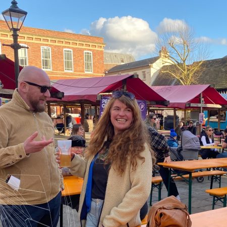 1 male and 1 female having a conversation at a food and drink market event