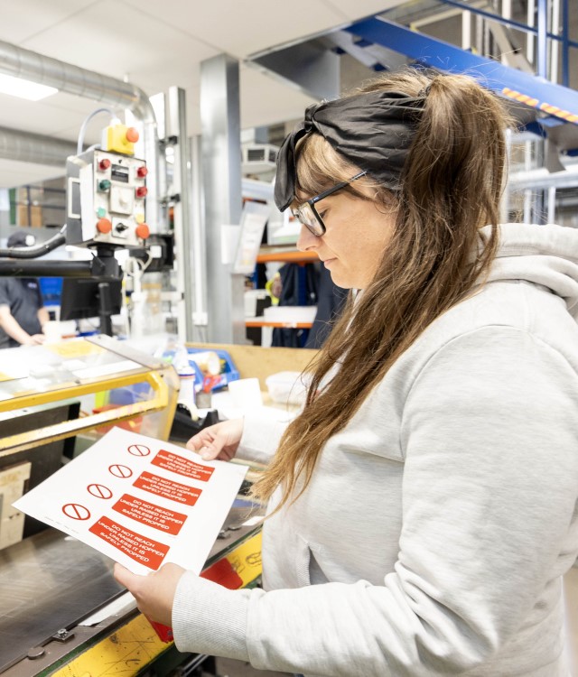Woman stood next to machinery