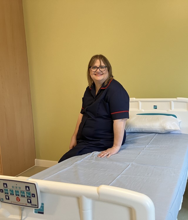 Nurse sat on bed at new mental health facility